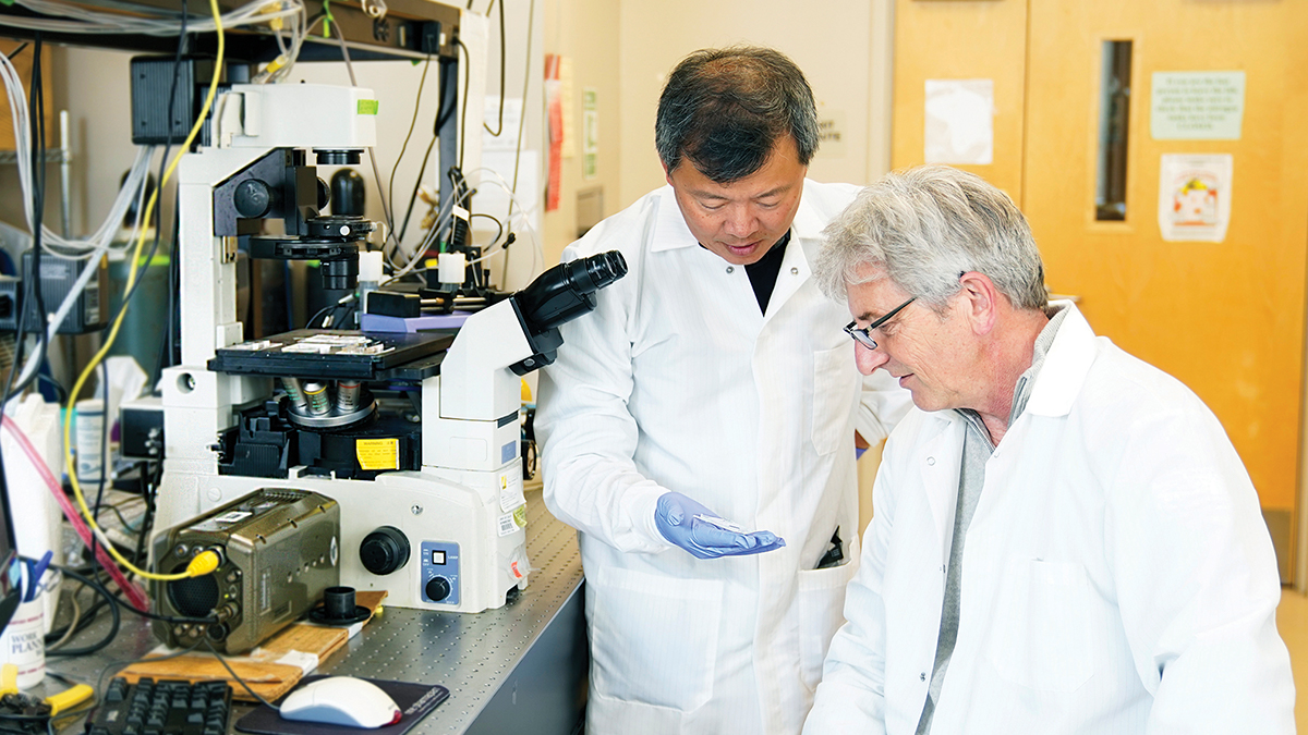 Abe Lee and Chris Hughes in a lab at uci