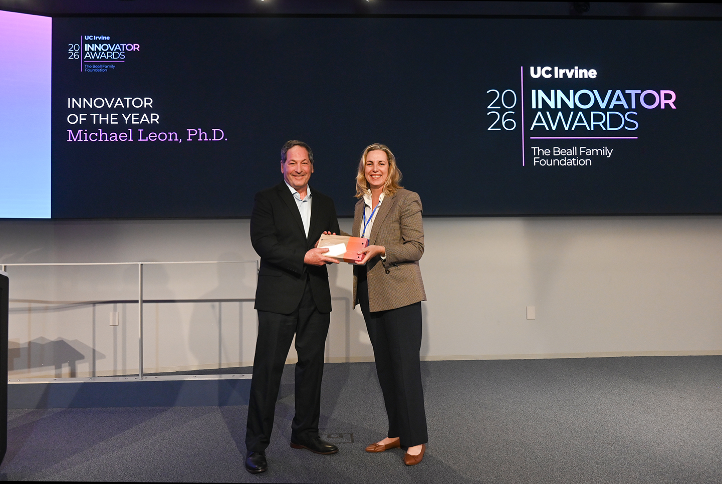 Casie Kelly, Ph.D. Director, Research Translation presenting the Innovator of the Year Award to Michael Leon, Ph.D.